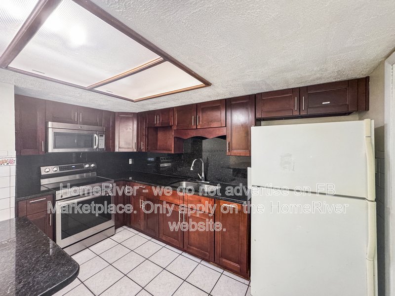 4 bedroom home with a fenced yard property image